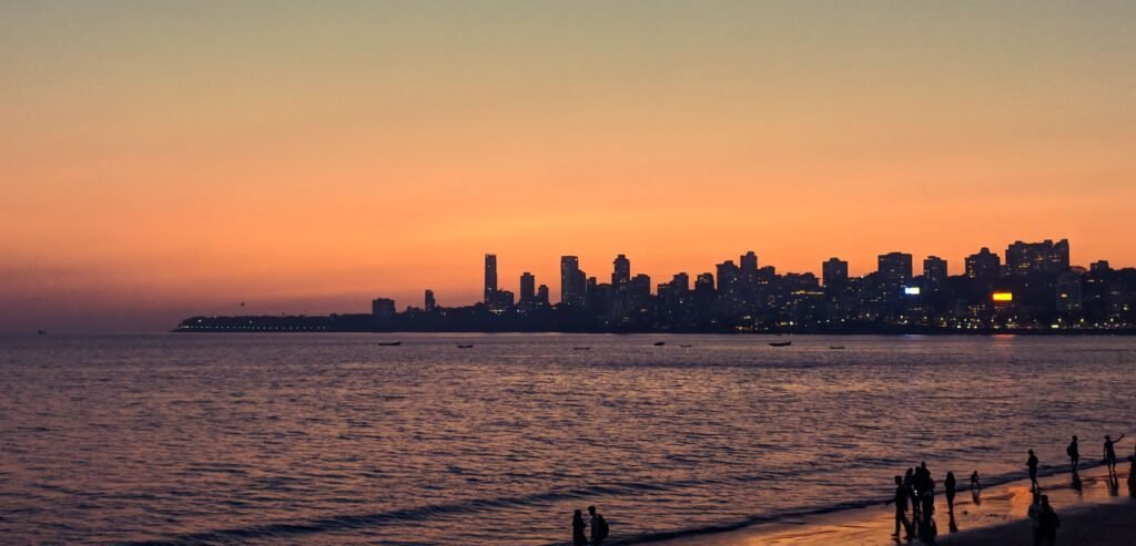 Breathtaking view of Mumbai's city skyline at sunset with a vibrant twilight sky.